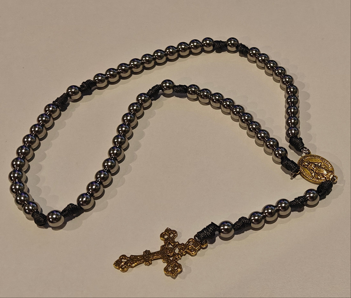 Gray gutted paracord rosary with gold miraculous medal and gold crucifix